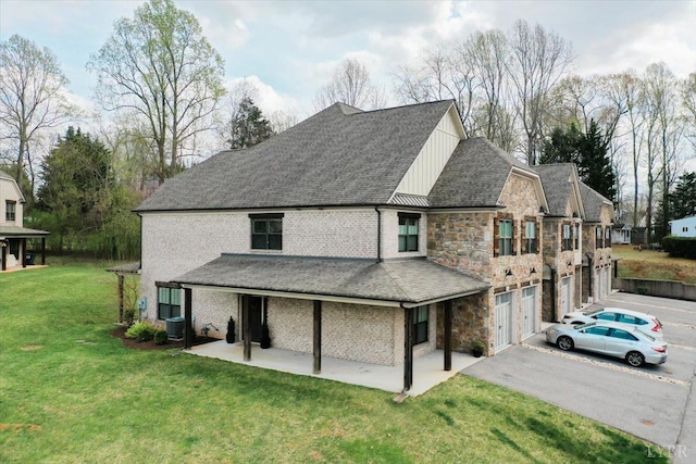 1031 Tori Ct, Forest, VA 24551 - view of front of home with driveway, an attached garage, a front lawn, cooling unit, and stone siding