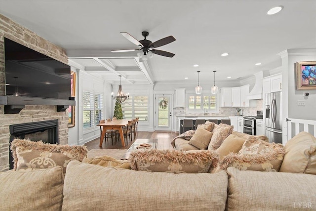 1031 Tori Ct, Forest, VA 24551 - living area featuring crown molding, ceiling fan, a chandelier, wood finished floors, and a fireplace