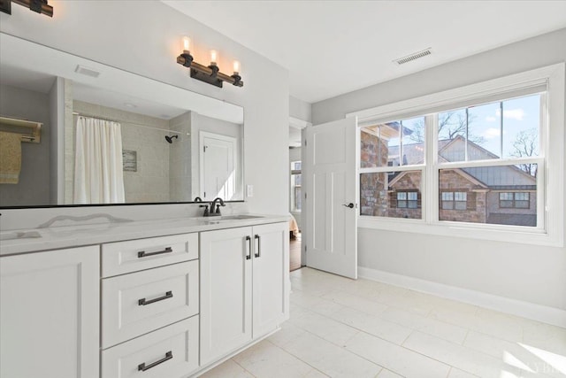 1031 Tori Ct, Forest, VA 24551 - full bathroom with double vanity, a tile shower, and baseboards