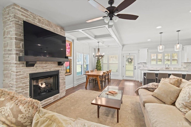 1031 Tori Ct, Forest, VA 24551 - living room with a chandelier, healthy amount of natural light, a fireplace, crown molding, and ceiling fan