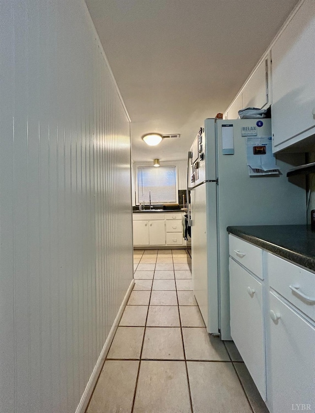 3101 Link Rd Unit 36, Lynchburg, VA 24503 - kitchen featuring dark countertops, light tile patterned floors, white cabinetry, and a sink