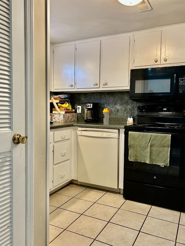 3101 Link Rd Unit 36, Lynchburg, VA 24503 - kitchen with black appliances, light tile patterned floors, dark countertops, and white cabinets