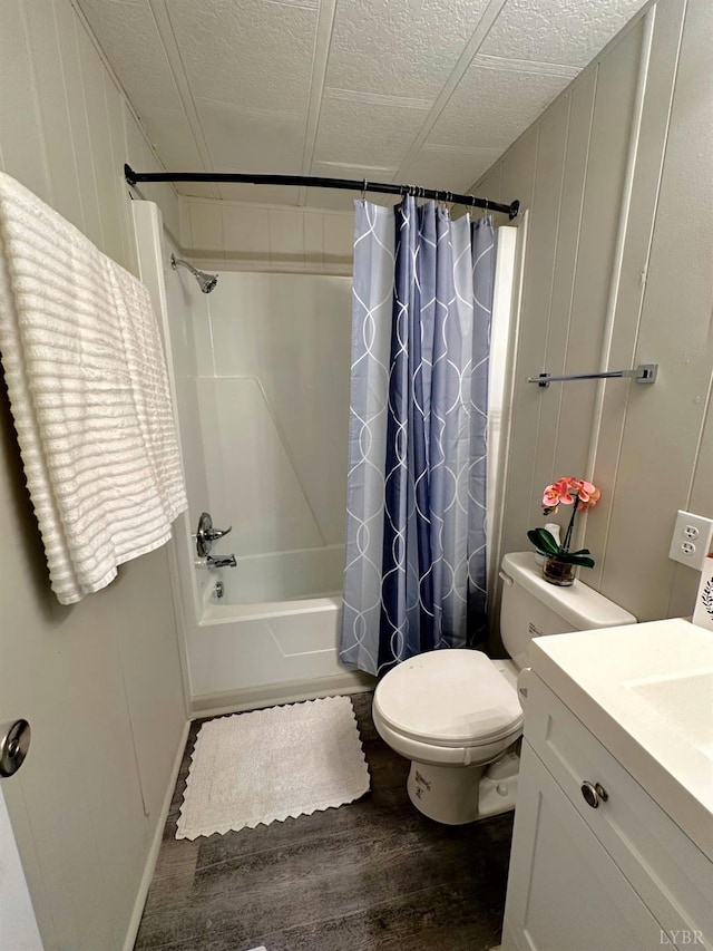 157 Phelps Rd, Madison Heights, VA 24572 - bathroom with wood finished floors, shower / bath combo with shower curtain, vanity, a decorative wall, and a textured ceiling