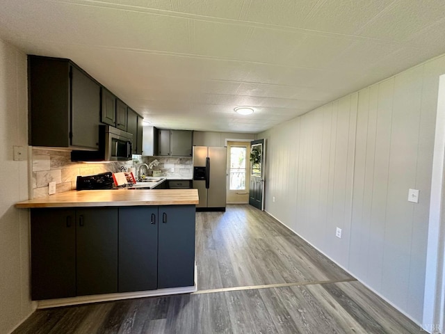 157 Phelps Rd, Madison Heights, VA 24572 - kitchen featuring stainless steel appliances, wood finished floors, a peninsula, decorative backsplash, and butcher block counters