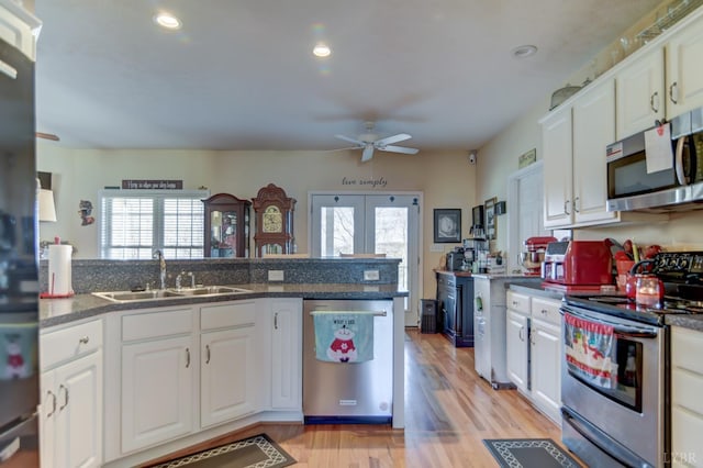 84 Jeter Ct, Lynchburg, VA 24501 - kitchen with appliances with stainless steel finishes, a sink, a ceiling fan, white cabinetry, and light wood finished floors