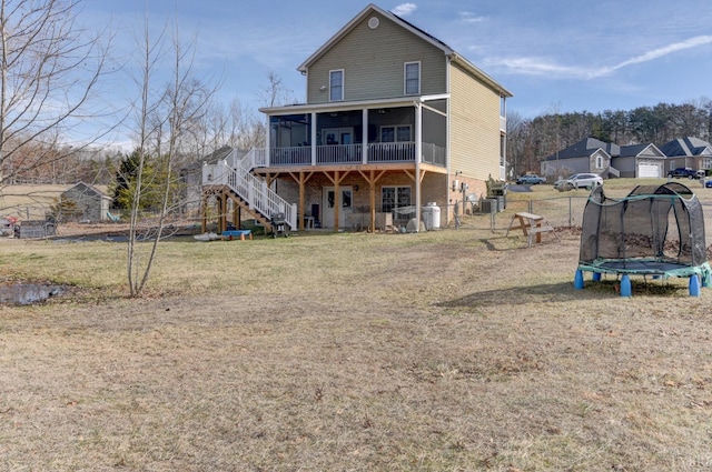 84 Jeter Ct, Lynchburg, VA 24501 - back of property with a sunroom, stairway, a trampoline, a gate, and a wooden deck
