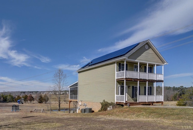 84 Jeter Ct, Lynchburg, VA 24501 - view of home's exterior with covered porch, solar panels, a balcony, metal roof, and a sunroom