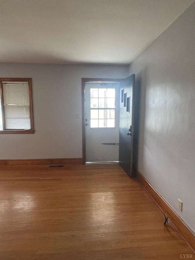 entryway featuring baseboards and wood finished floors
