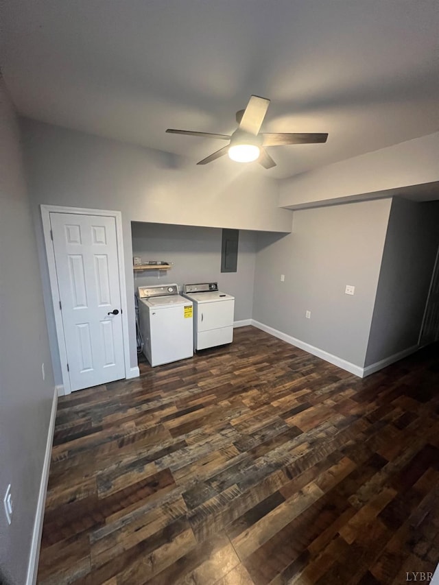 interior space featuring electric panel, a ceiling fan, dark wood-style flooring, baseboards, and separate washer and dryer