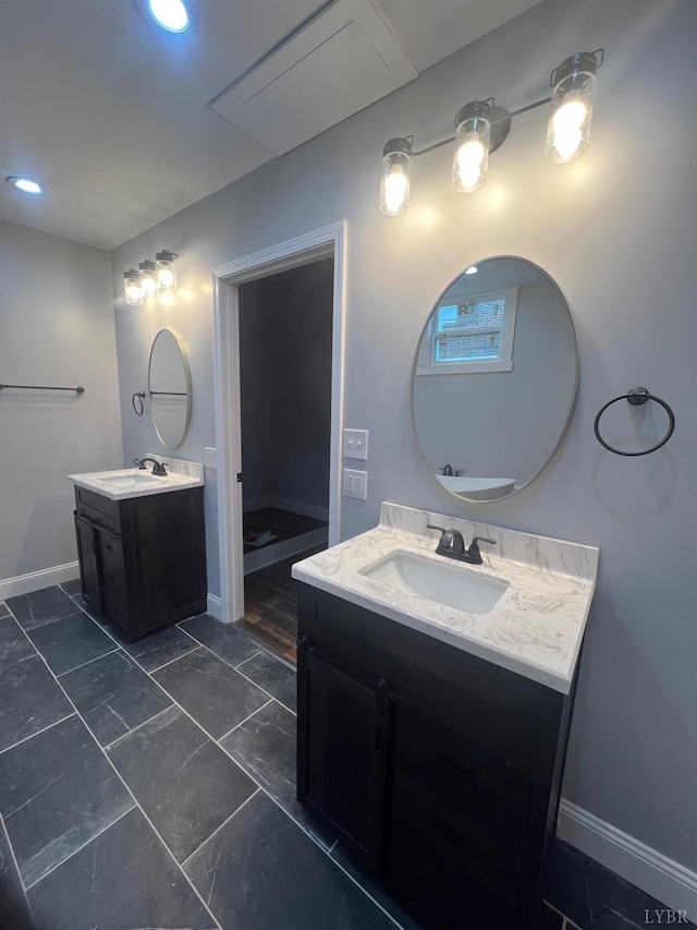 full bathroom with a sink, baseboards, recessed lighting, and two vanities