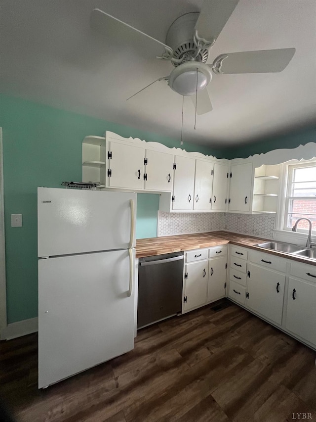 kitchen with ceiling fan, dishwasher, a sink, freestanding refrigerator, and white cabinetry