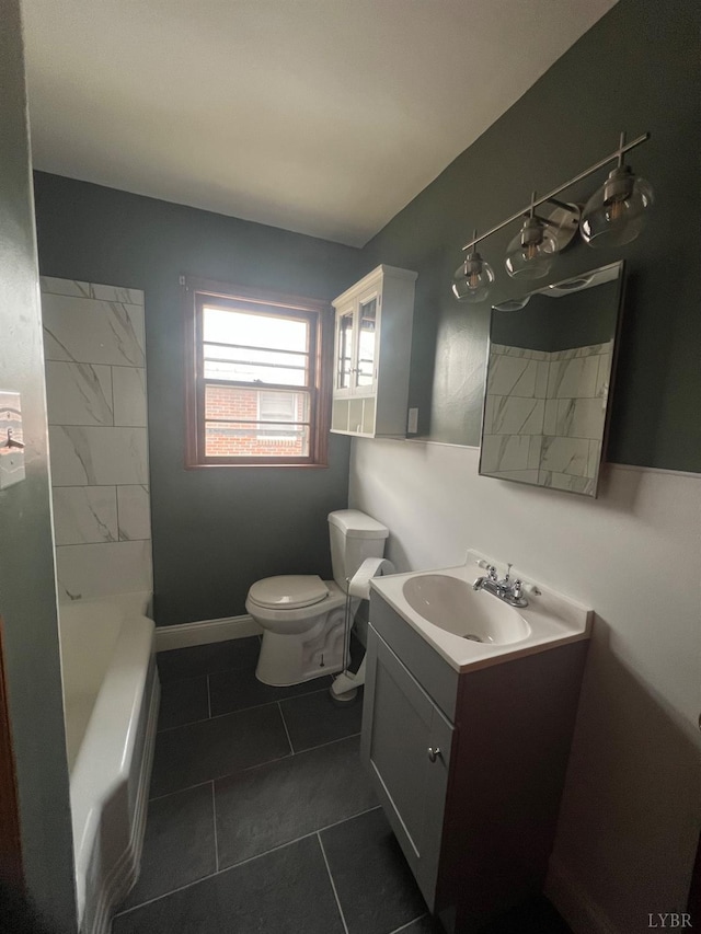 bathroom with toilet, tile patterned floors, a tub, and vanity