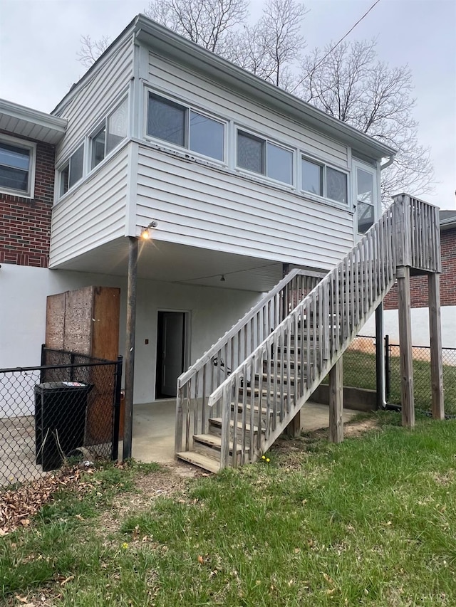 back of property featuring fence and stairway
