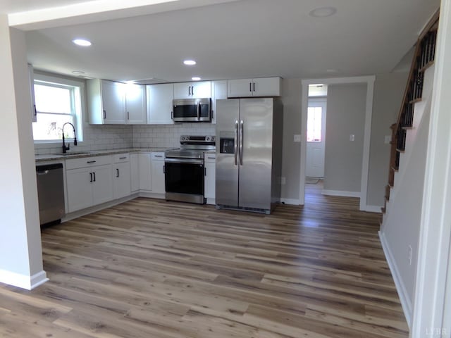 1021 Bowman Ln, Bedford, VA 24523 - kitchen featuring stainless steel appliances, a sink, white cabinetry, light wood-type flooring, and recessed lighting