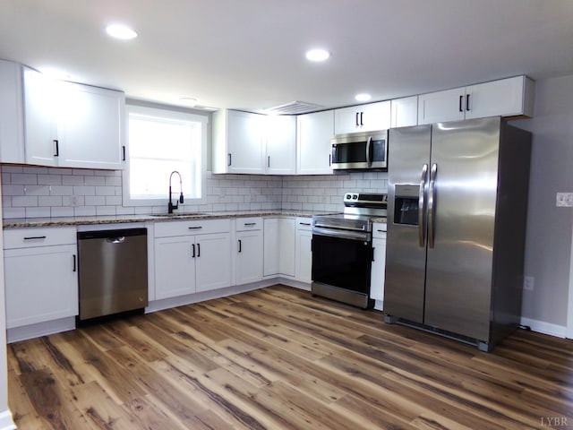 1021 Bowman Ln, Bedford, VA 24523 - kitchen with stainless steel appliances, a sink, light stone countertops, white cabinets, and recessed lighting