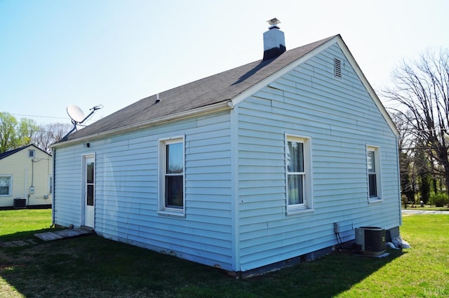 272 Jasper Wood Rd, Hurt, VA 24563 - rear view of house with a yard, central AC unit, and a chimney