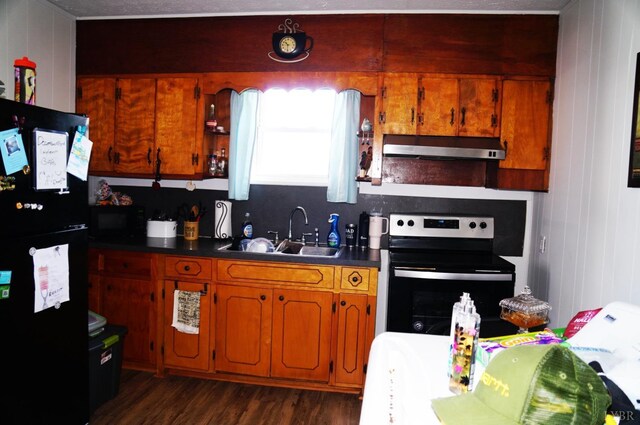 272 Jasper Wood Rd, Hurt, VA 24563 - kitchen featuring a sink, under cabinet range hood, brown cabinetry, black appliances, and dark wood-type flooring