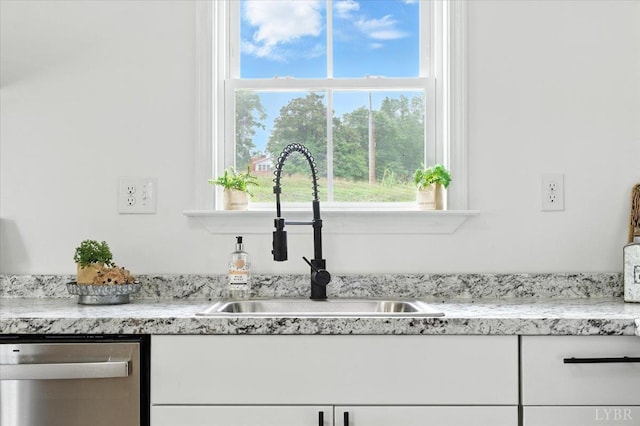 109 Ned Brown Rd, Amherst, VA 24521 - kitchen view of stainless steel dishwasher, white cabinets, and light stone counters