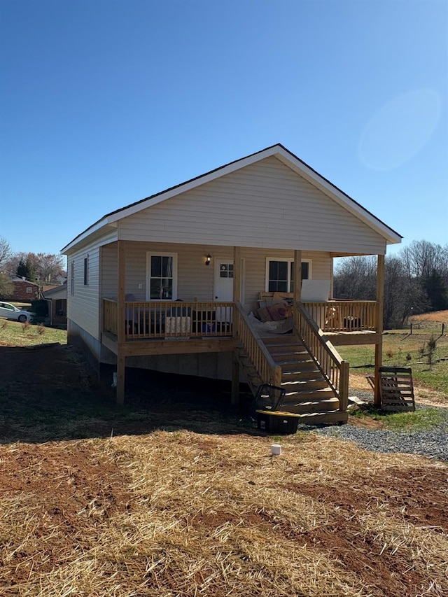 view of front of home featuring covered porch and stairway