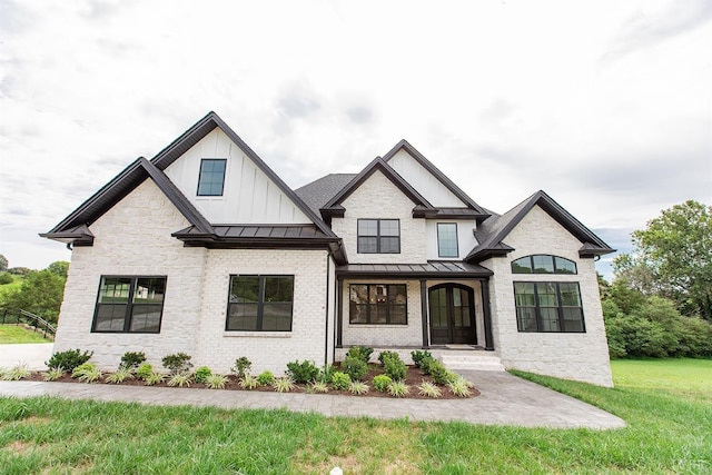 14 Deer Hollow Rd, Forest, VA 24551 - modern inspired farmhouse featuring board and batten siding, a standing seam roof, metal roof, a front yard, and stone siding