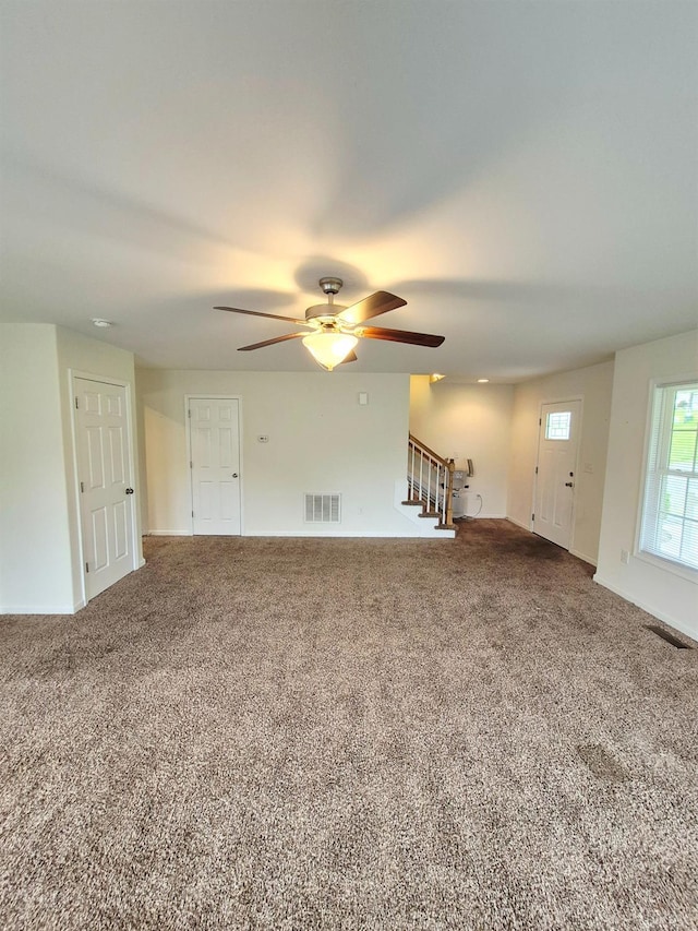 188 Oak Spring Ln, Madison Heights, VA 24572 - unfurnished living room with ceiling fan, stairway, and carpet floors
