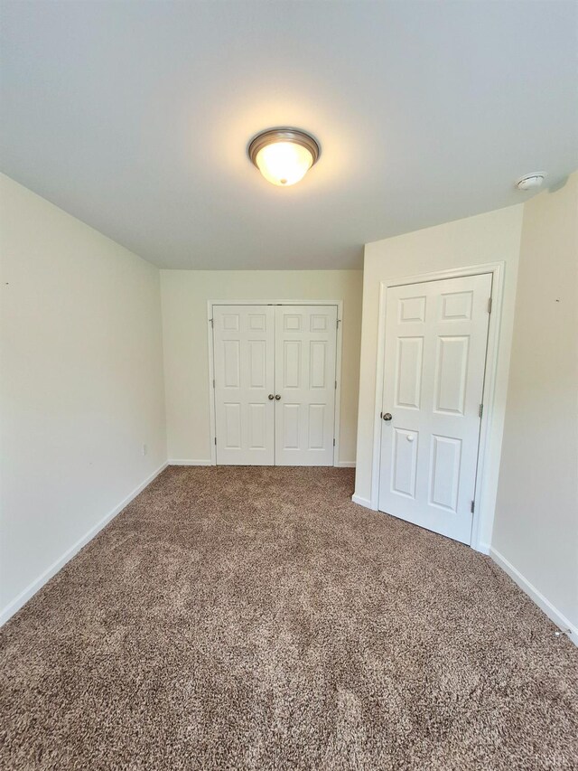 188 Oak Spring Ln, Madison Heights, VA 24572 - unfurnished bedroom with a closet and carpet floors