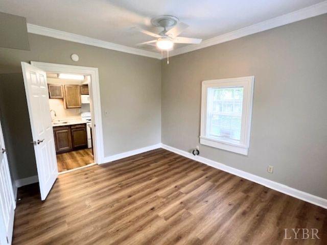2024 Poplar St, Lynchburg, VA 24504 - empty room featuring ornamental molding, a ceiling fan, and dark wood-style flooring