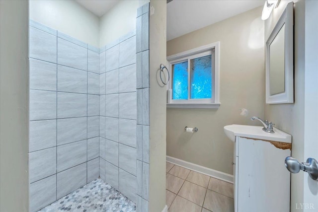1048 Grove Ln, Roanoke, VA 24012 - bathroom featuring tile patterned floors, vanity, baseboards, and tiled shower