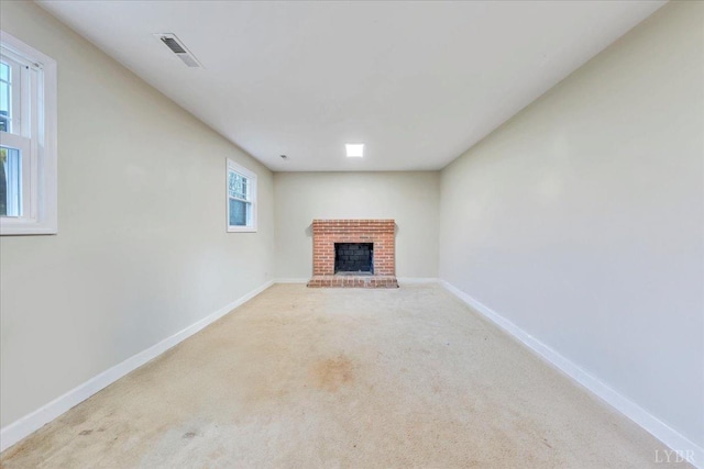1048 Grove Ln, Roanoke, VA 24012 - unfurnished living room with a brick fireplace, baseboards, and carpet