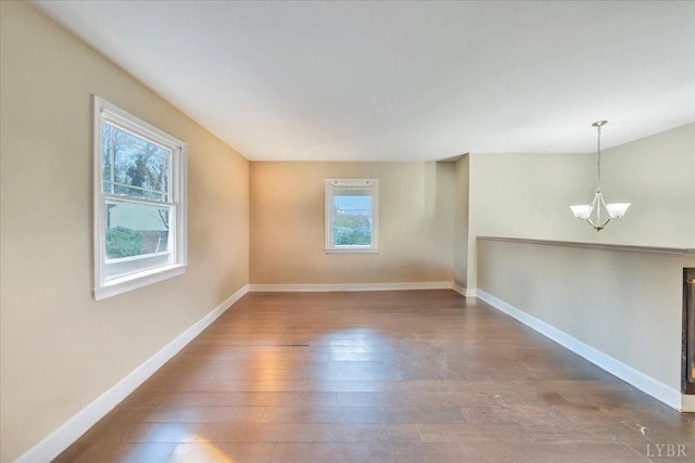 1048 Grove Ln, Roanoke, VA 24012 - unfurnished room featuring a chandelier, hardwood / wood-style flooring, and baseboards