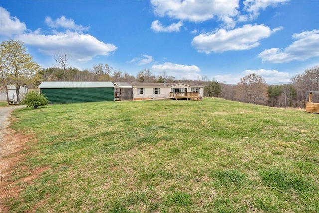 back of house with a deck and a lawn