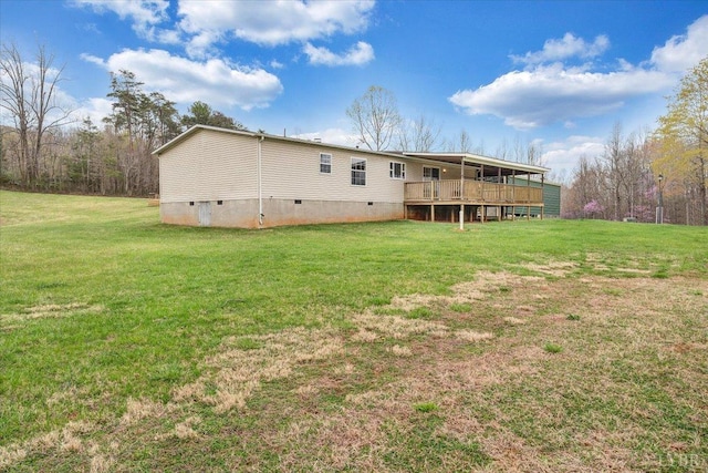 rear view of house featuring a yard, a deck, and crawl space