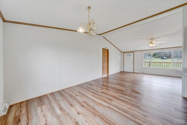 unfurnished room with crown molding, visible vents, lofted ceiling, ceiling fan with notable chandelier, and wood finished floors