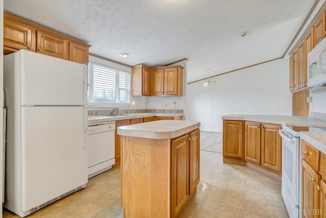 kitchen with white appliances, a textured ceiling, a kitchen island, light countertops, and brown cabinets