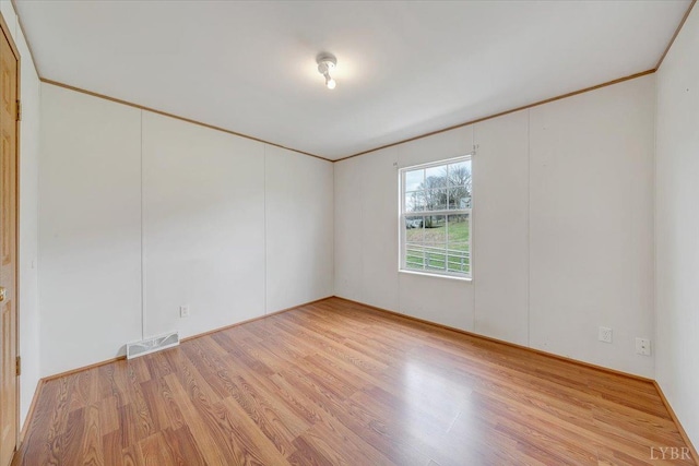 spare room with visible vents and light wood-style floors
