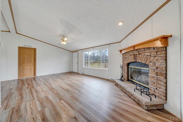 unfurnished living room featuring visible vents, ceiling fan, light wood-style floors, crown molding, and lofted ceiling