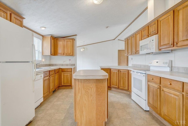 kitchen featuring a center island, light countertops, white appliances, and light floors