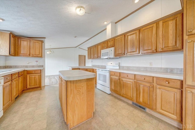 kitchen featuring light countertops, white appliances, light floors, and a kitchen island
