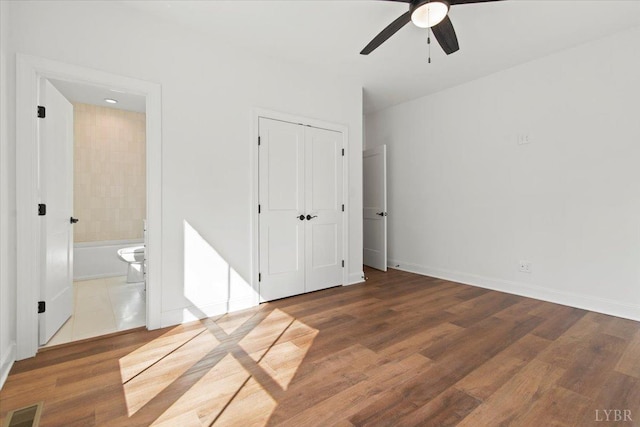 1148 Val Ter, Forest, VA 24551 - unfurnished bedroom featuring ceiling fan, ensuite bath, visible vents, wood finished floors, and baseboards