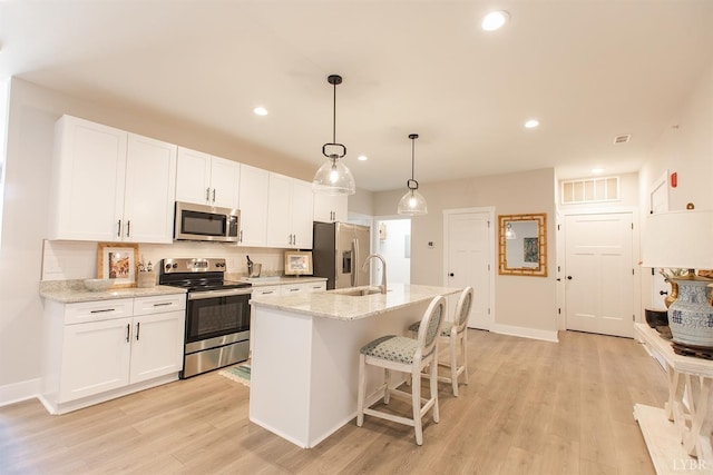 1300 Stoney Ridge Blvd Unit 206, Forest, VA 24551 - kitchen with a center island with sink, light wood-style flooring, stainless steel appliances, and white cabinetry