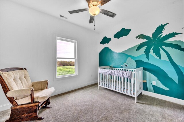 664 Collins Ferry Rd, Gladys, VA 24554 - carpeted bedroom with baseboards, a crib, and ceiling fan