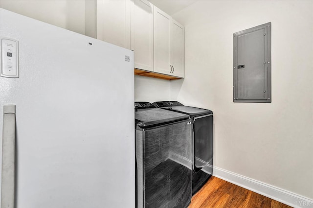 664 Collins Ferry Rd, Gladys, VA 24554 - laundry room featuring electric panel, cabinet space, washing machine and dryer, wood finished floors, and baseboards