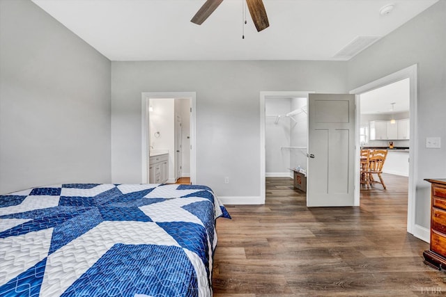 664 Collins Ferry Rd, Gladys, VA 24554 - bedroom featuring wood finished floors, a spacious closet, baseboards, connected bathroom, and ceiling fan