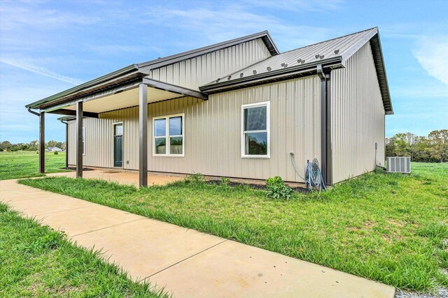 664 Collins Ferry Rd, Gladys, VA 24554 - view of property exterior with metal roof, a standing seam roof, a lawn, central AC, and a patio area