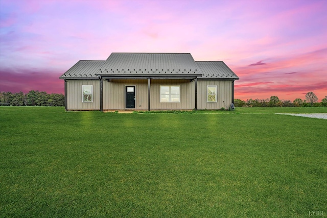 664 Collins Ferry Rd, Gladys, VA 24554 - back of property at dusk featuring board and batten siding, a lawn, and metal roof