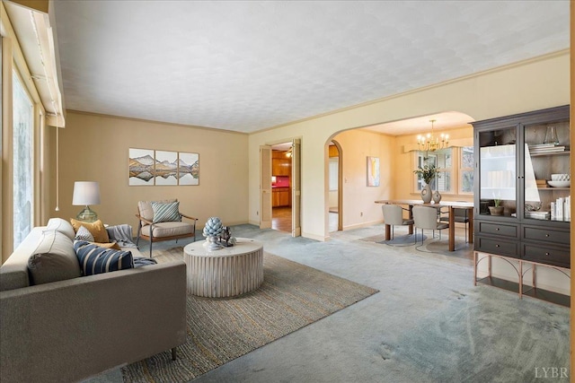 123 Knollwood Dr, Hurt, VA 24563 - living room with arched walkways, a chandelier, healthy amount of natural light, and carpet floors
