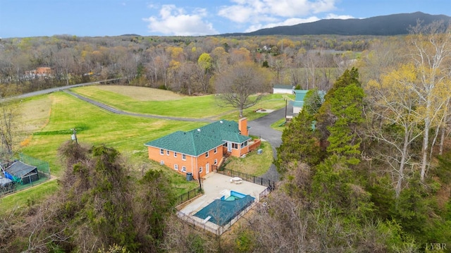 view from above of property with a forest and a pool