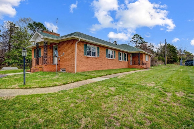 view of side of home featuring brick siding and a lawn