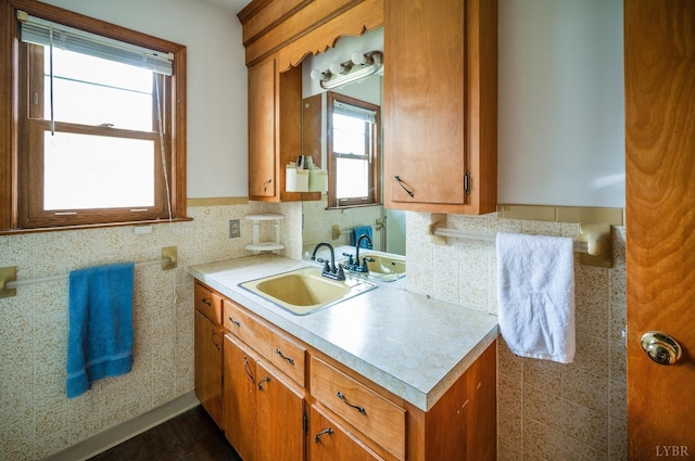kitchen with a sink, light countertops, and brown cabinetry
