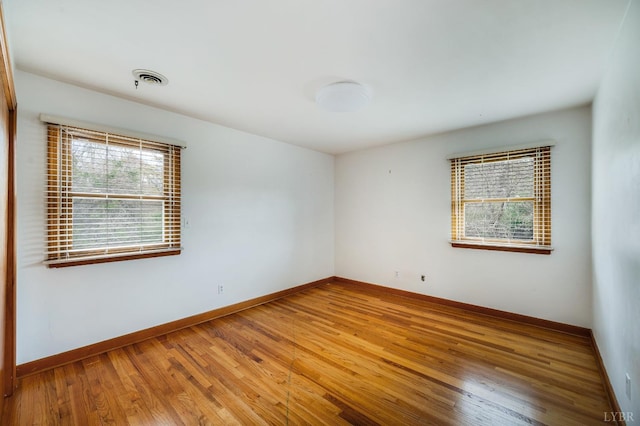 empty room with wood finished floors and baseboards